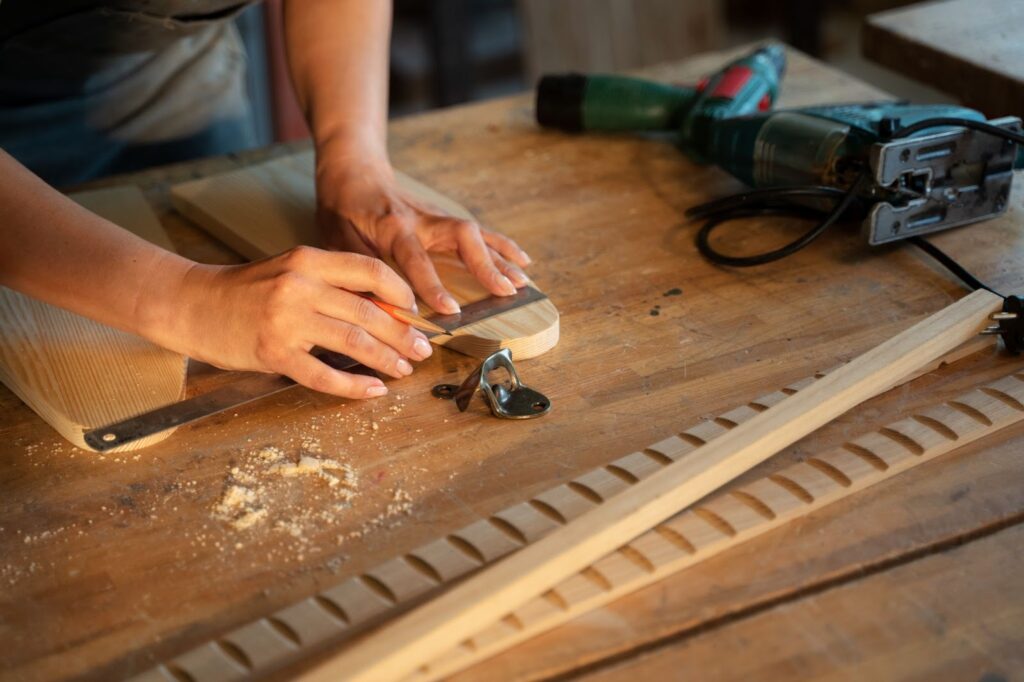 Woman measuring a piece of wood with a ruler