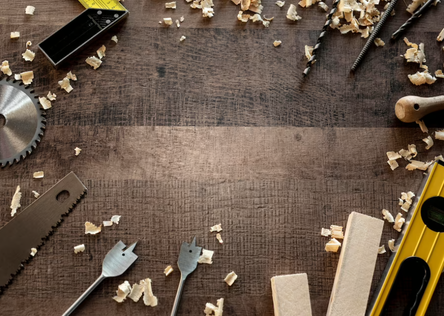 saw and other tools on the wooden dark table