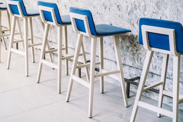 Several bar stools with white legs