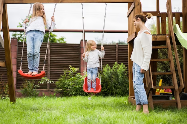 Children riding on the swings in the yard